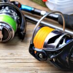 Close-up of vibrant fishing reels on rustic wood, showcasing essential fishing gear for enthusiasts.