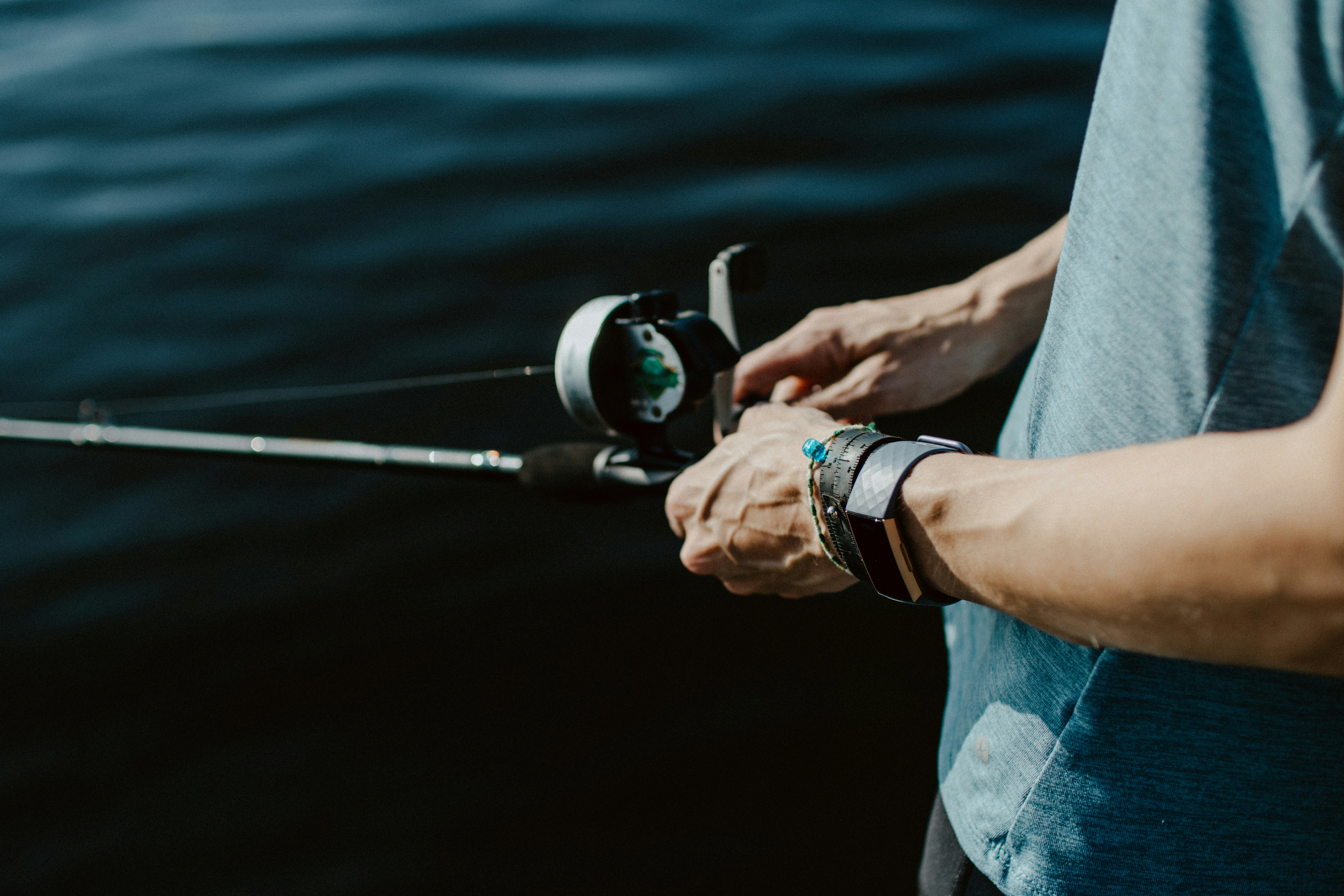 Focused angler holding a fishing rod, showcasing the art of fishing in natures tranquility.