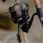 Close-up of a lightweight fishing reel with braided line, perfect for anglers.