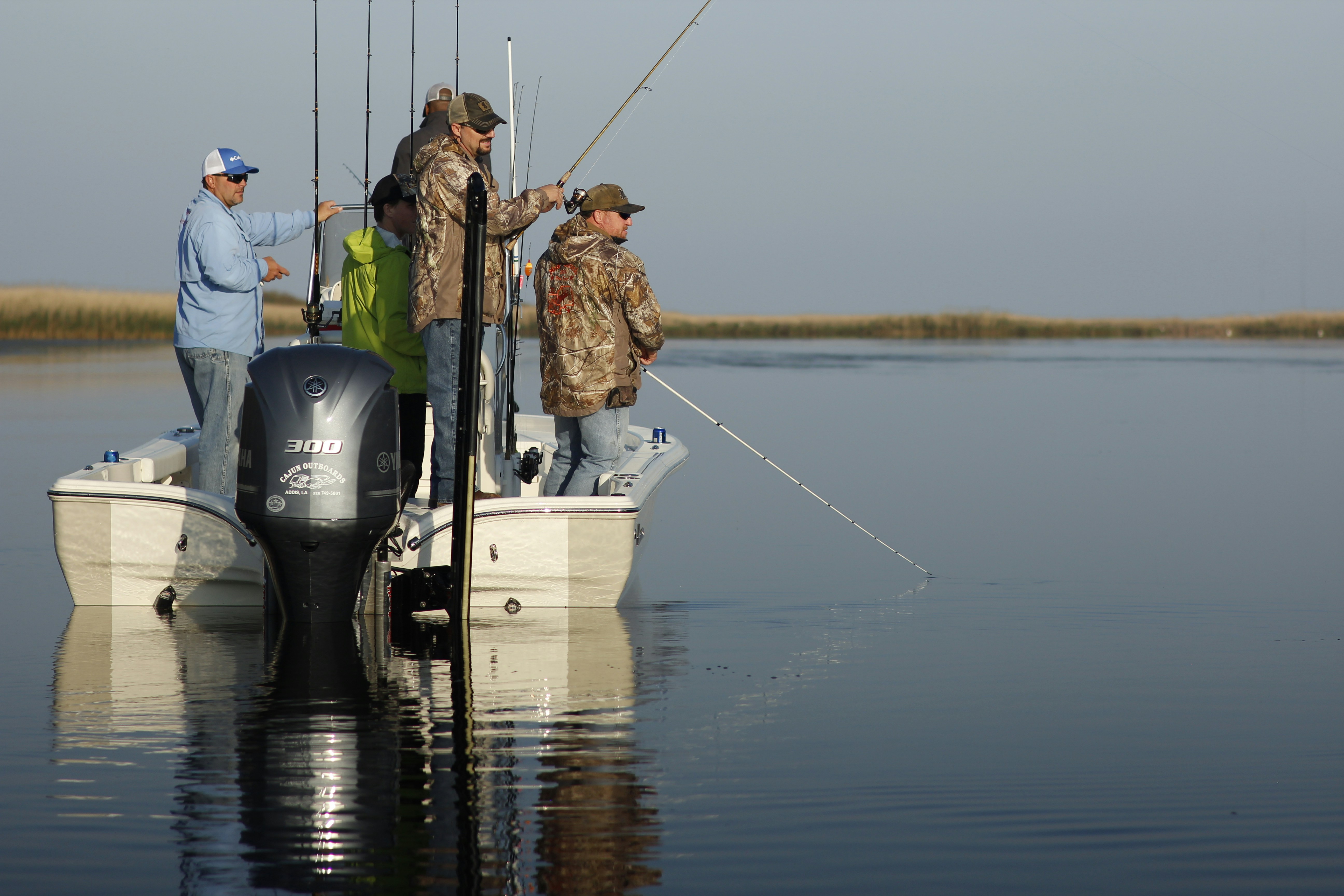 Fishermen enjoy a tranquil morning fishing trip on a boat in serene waters.